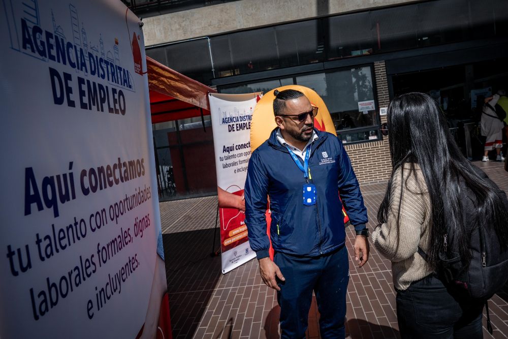 Imagen relacionada con una mujer que recibe orientación en feria de empleo