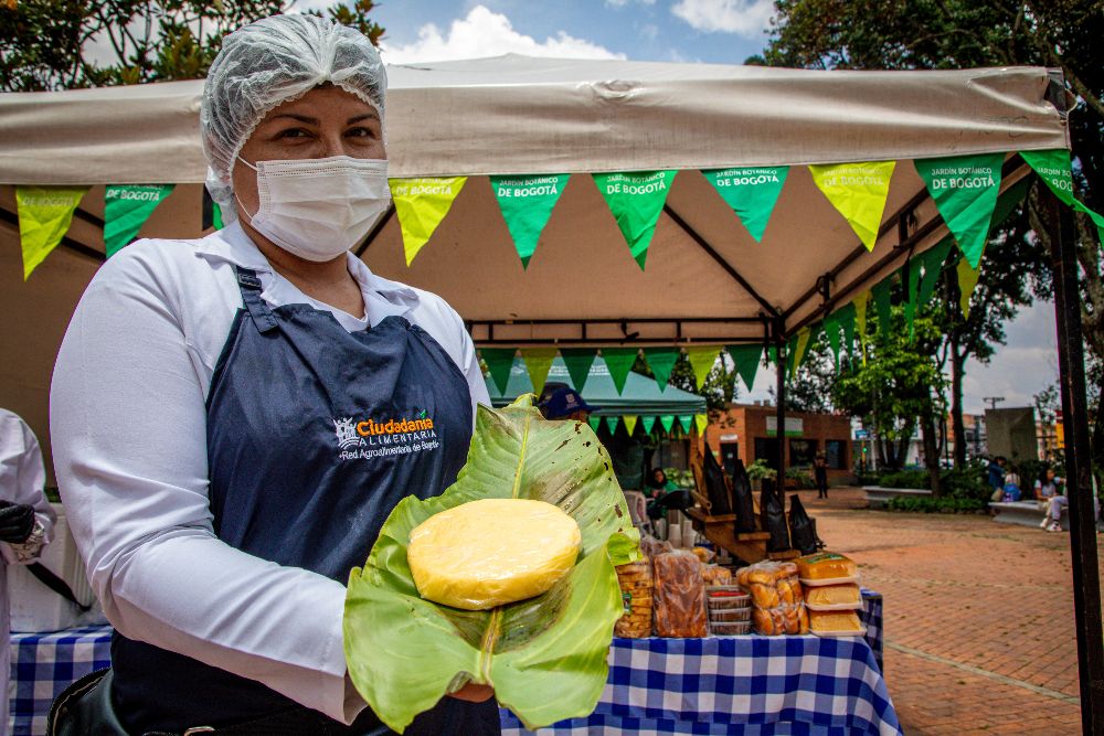 Imagen relacionada con una mujer campesina que presenta su producto