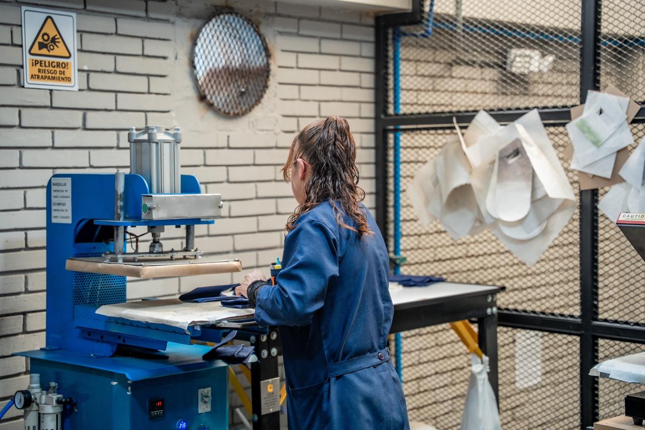 Imagen relacionada con una mujer que realiza labores en una fábrica de textiles